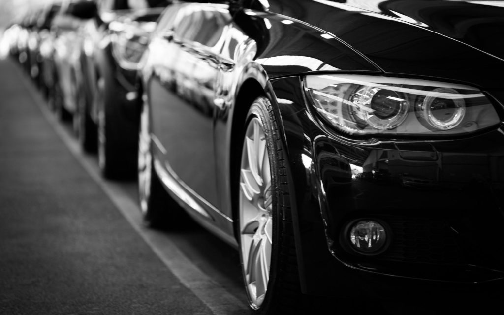 a lineup of cars in black and white